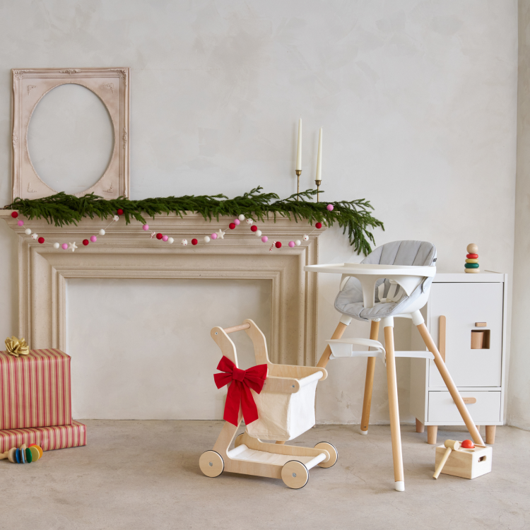 The Chair, Shopping Cart and The Play Fridge in front of holiday decorations and wrapped gifts